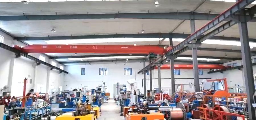 Production hall with overhead crane and multiple cable lines
