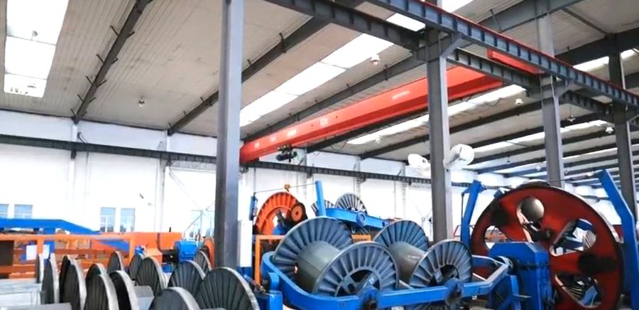 Workshop overview showing stranding and take-up equipment